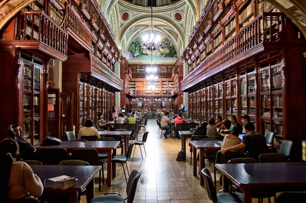 People studying in a quiet wood-paneled library