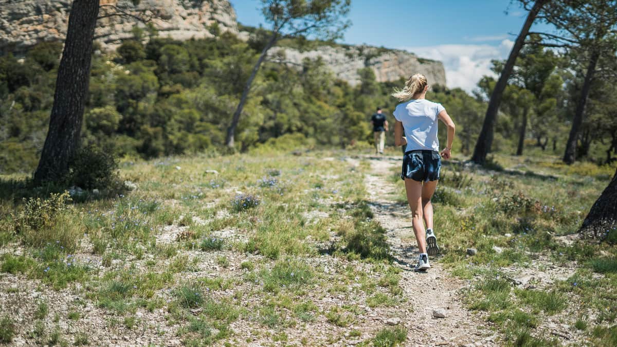 A woman running on a mountain trail